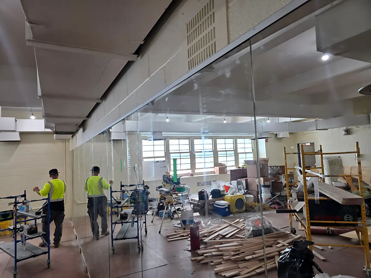 Installers setting glass partition panels